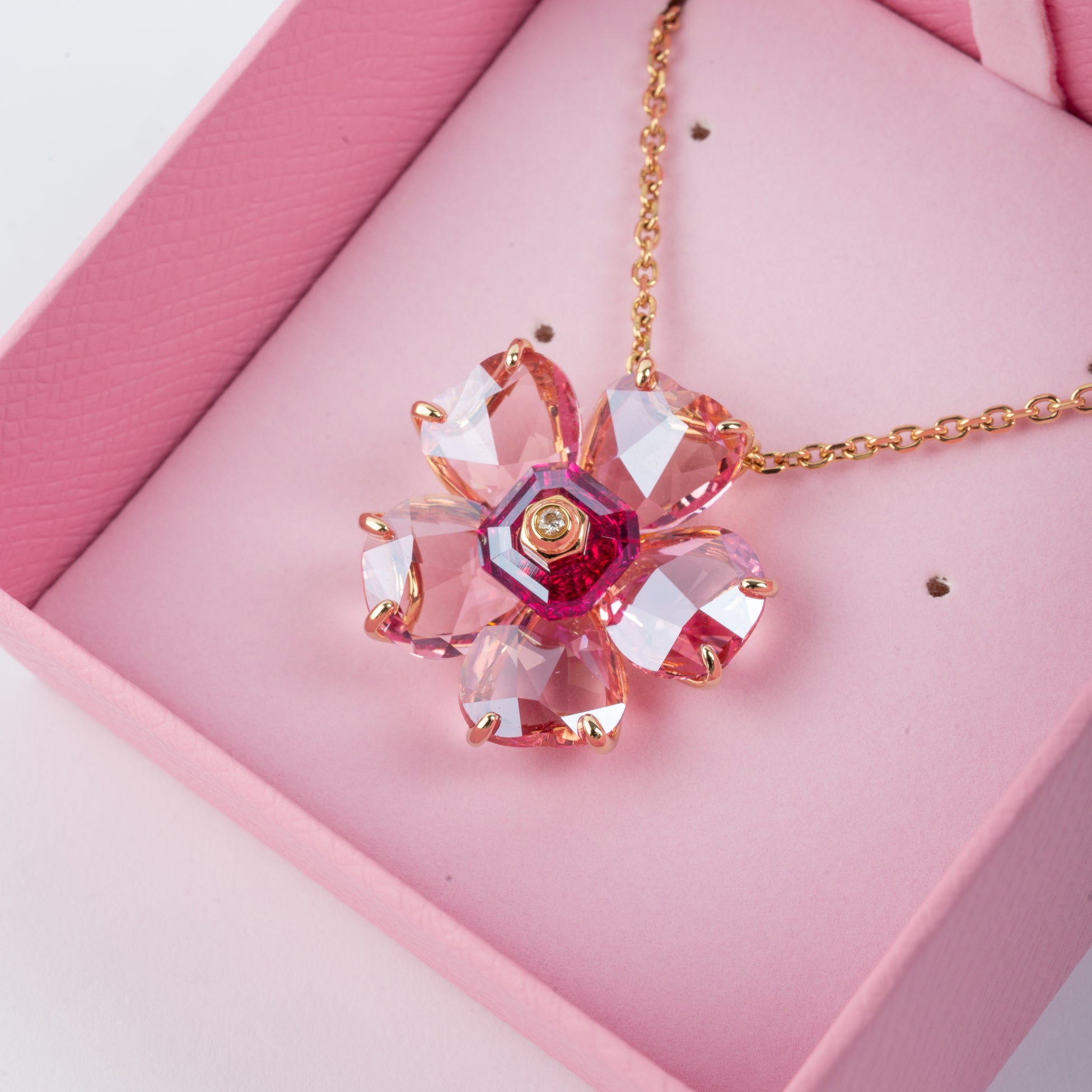 Flickering Floral Pendant selling in Pink on Gold Plated Flat Figaro Chain